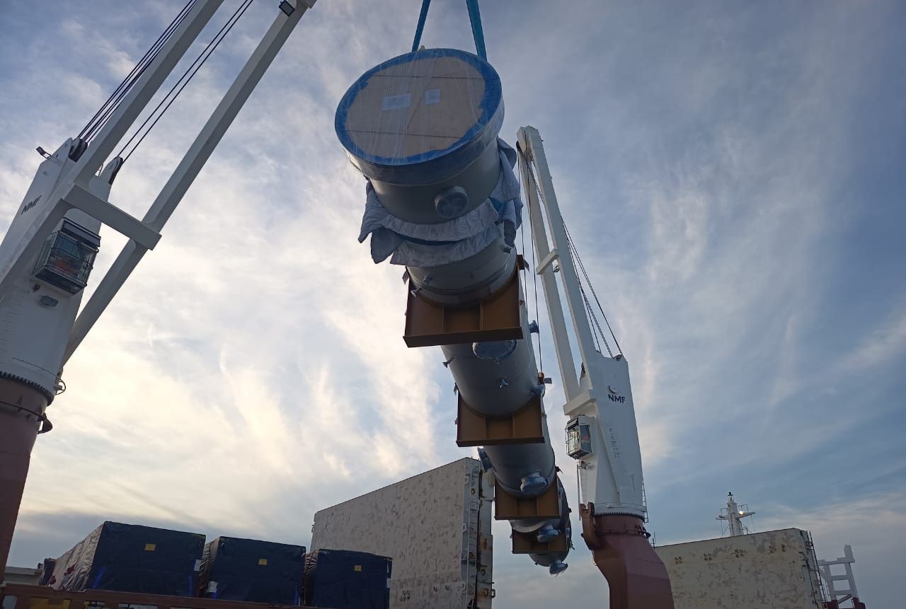 Image of crane lifting concrete pipe